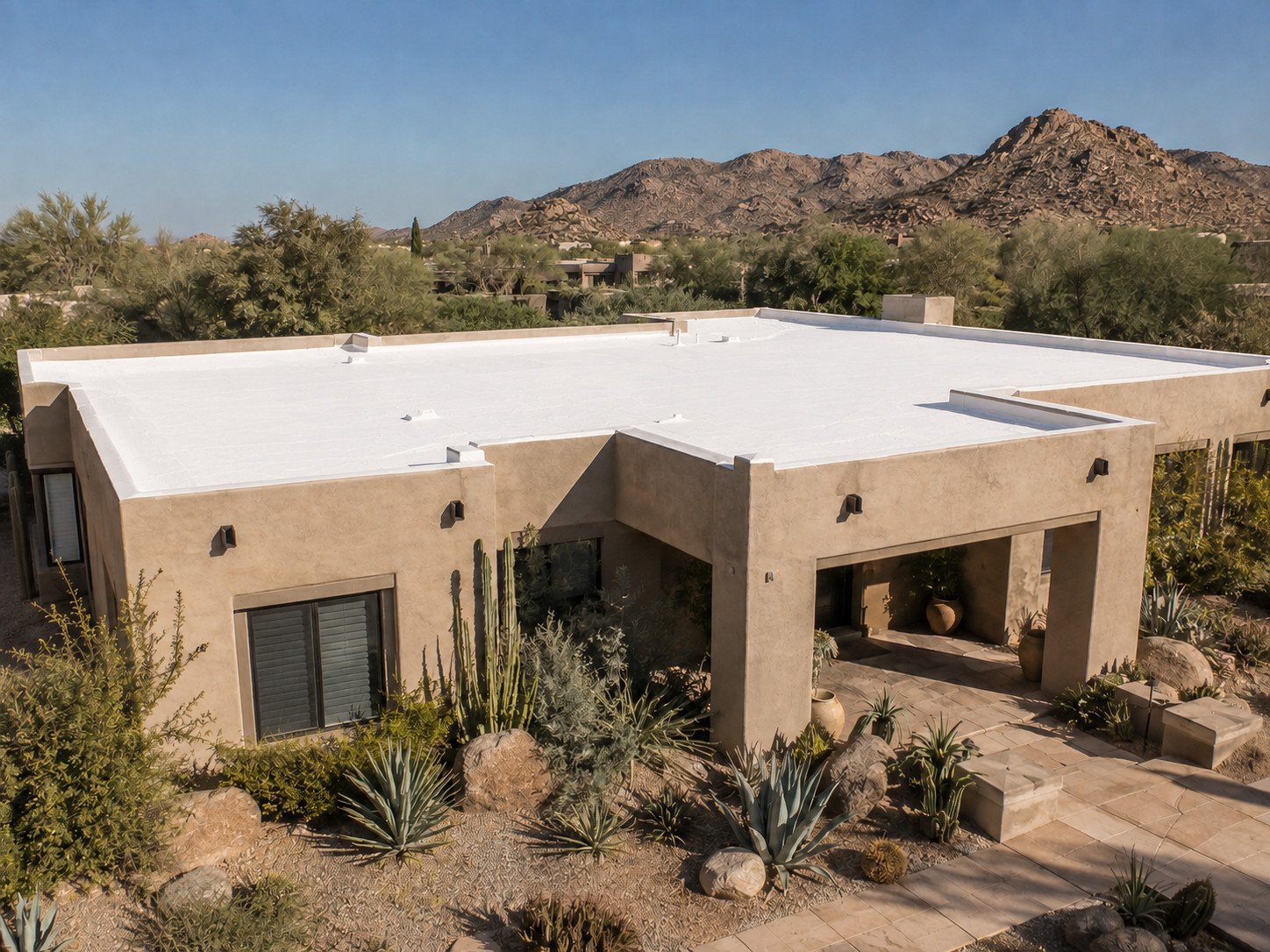 The same desert home after the spray foam roof was recoated, the deck now a clean uniform white
