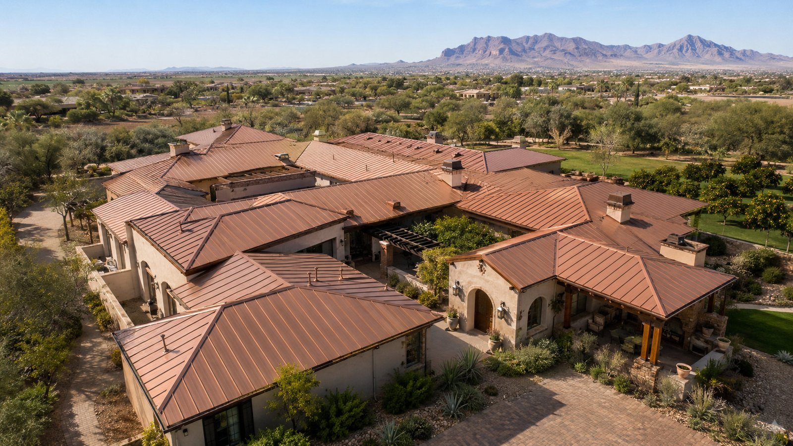 Estate home with warm tile-profile roofing and mountain views