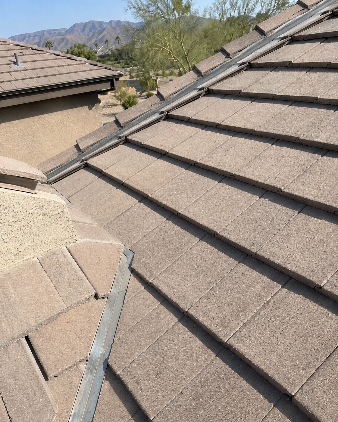 The same valley after repair, with new valley metal and the tile field relaid flush